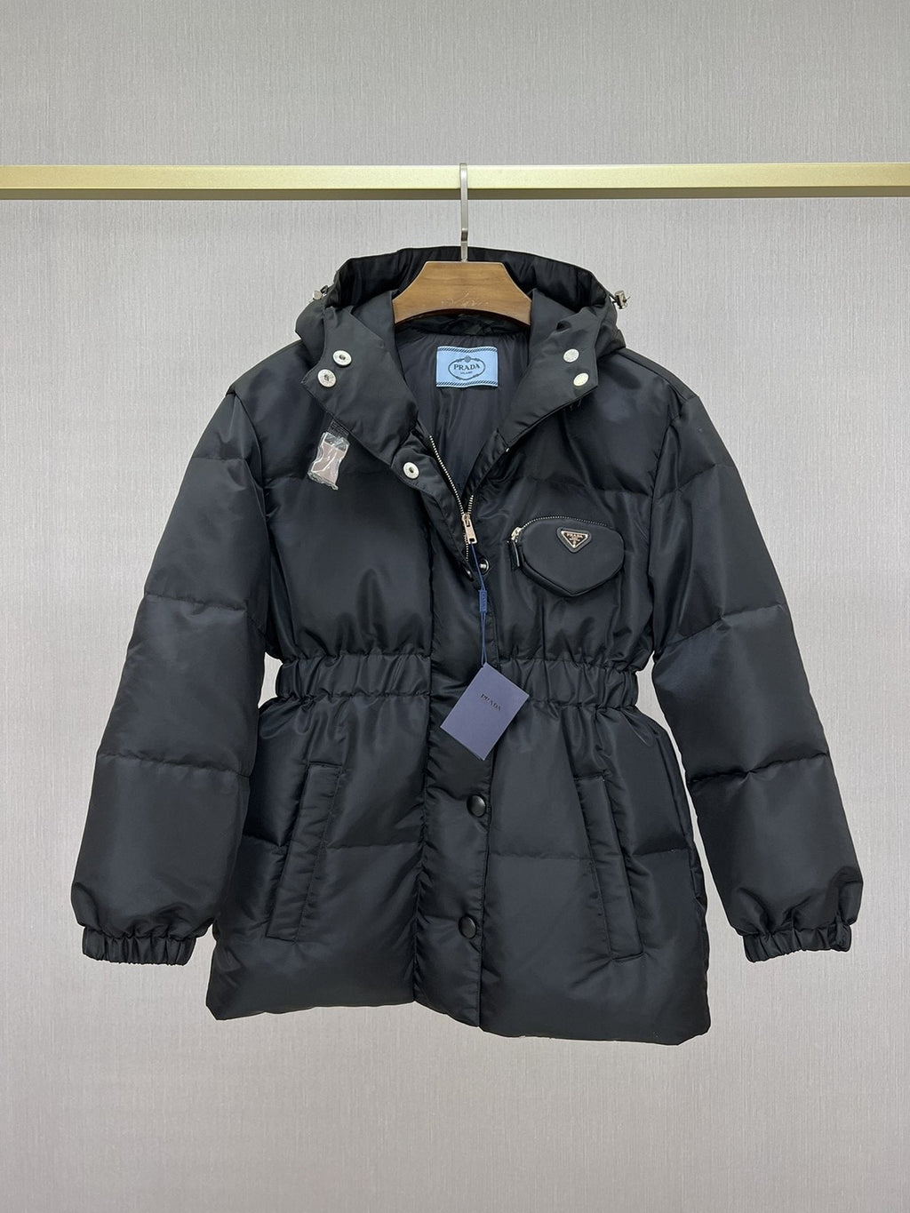 Prada Hooded Gathered-Waist Puffer Jacket — hang_tag