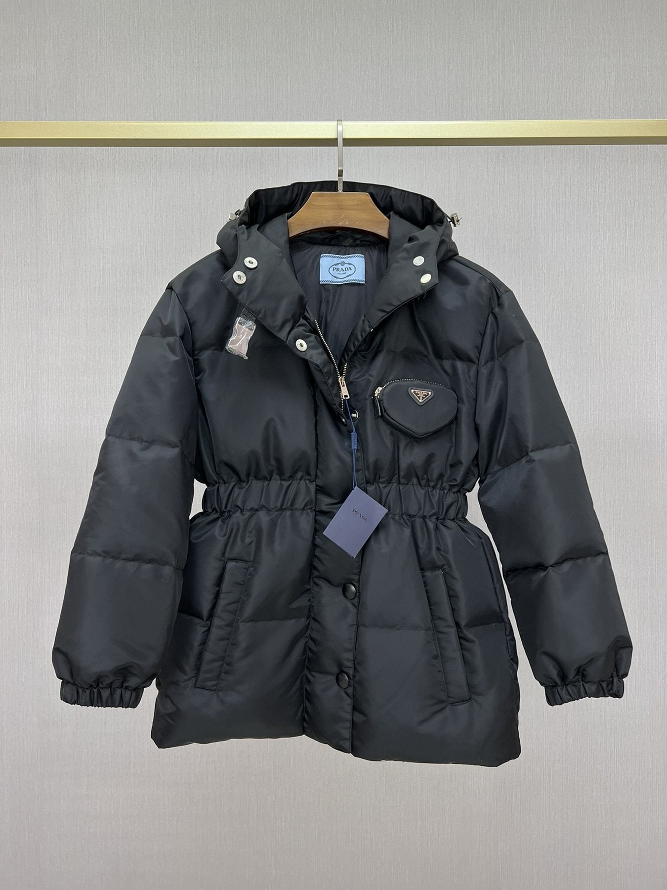Prada Hooded Gathered-Waist Puffer Jacket — hang_tag